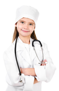 Adorable smiling little girl dressed as a doctor with stethoscope isolated on a white